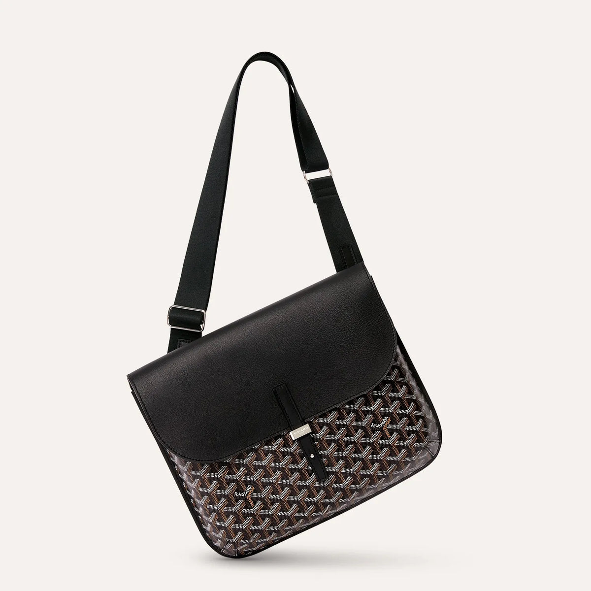 Side angle view of luxury Goyardine canvas messenger bag in black
